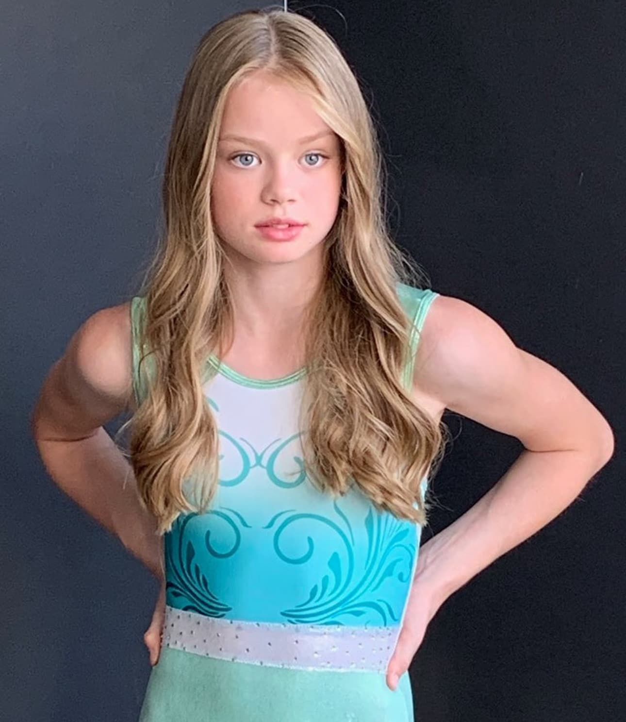 Natasha as a young gymnast in a mint leotard